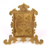 A VICTORIAN ORMOLU PHOTOGRAPH FRAME of easel design, with strapwork hinges to the twin doors to