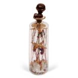 AN ANTIQUE PRISONER OF WAR 'GOD IN A BOTTLE' the cylindrical glass bottle with turned stopper