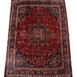 AN IRANIAN LATE 20TH CENTURY SMALL RED GROUND CARPET with a banded border and stylised foliate