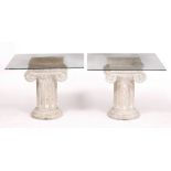A PAIR OF LIMED OCCASIONAL TABLES in the form of fluted ionic columns, each with glass tops, the