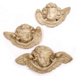 A GROUP OF THREE LATE 17TH OR EARLY 18TH CENTURY CARVED WOODEN CHERUBS later painted white, the