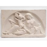 A CAST PLASTER PLAQUE, AFTER THE ANTIQUE, depicting a reclining female figure feeding grapes to a