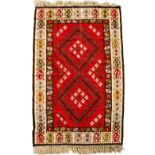 A KELIM POLYCHROME RUG with geometric medallion decoration 133cm x 213cm