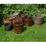 A GROUP OF EIGHT CHINESE WOODEN IRON BOUND BUCKETS with iron loop handles, all approximately 33cm