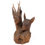 AN OLD BLACK FOREST PINE CARVING of two deer heads, approximately 39cm wide x 59cm high