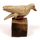 AN 18TH CENTURY CARVED AND PAINTED NAIVE SCULPTURE of a dove approximately 16cm long x 8cm high,