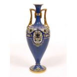 A ROYAL WORCESTER TWIN HANDLED OVOID VASE standing on spreading socle base with hand painted