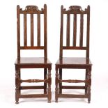 A PAIR OF LATE 17TH CENTURY OAK HIGH BACKED SIDE CHAIRS with carved cresting rails, vertical splats,