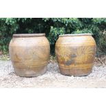 A PAIR OF LARGE ORIENTAL HONEY GLAZED OVOID PLANTERS decorated with dragons, each approximately 62cm