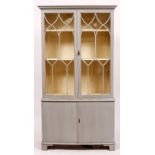 A GEORGIAN STYLE GREY PAINTED BOW FRONTED BOOKCASE the upper section with astragal glazed doors