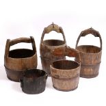 A GROUP OF CHINESE WOODEN CYLINDRICAL BUCKETS some with iron mounts and some with carved script, the