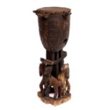 A MID TO LATE 20TH CENTURY AFRICAN CARVED WOODEN DRUM with stretched hide held on by four animal