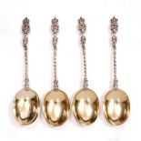 A SET OF FOUR VICTORIAN SILVER SPOONS each with parcel gilt oval bowls, cast stems and with