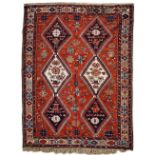 A SOUMAK RED GROUND CARPET with two rows of three diamond motifs, a banded border and geometric