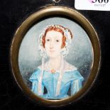 AN EARLY TO MID 19TH CENTURY MINIATURE PORTRAIT of a lady wearing a bonnet painted on ivory 8cm x