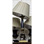 A GILDED AND EBONISED TABLE LAMP of column form with acanthus leaf decoration and a square base,