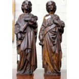 A PAIR OF WOODEN HAND CARVED RELIGIOUS FIGURES the tallest measuring 51cm approximately (2)
