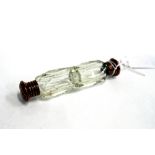 AN EARLY 20TH CENTURY FACETED CLEAR GLASS DOUBLE ENDED SCENT BOTTLE 12cm in length