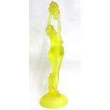 ART DECO STYLE YELLOW GLASS FIGURE GROUP depicting a female figure holding grapes, standing on a