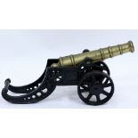 A BRASS AND CAST IRON MODEL CANNON overall 46cm in length