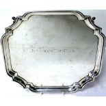 A MID 20TH CENTURY SILVER SALVER with marks for Birmingham 1954, with a shaped edge and four feet,