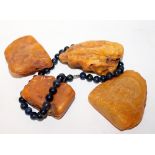 FOUR PIECES OF RAW AMBER and a Lapis Lazuli necklace