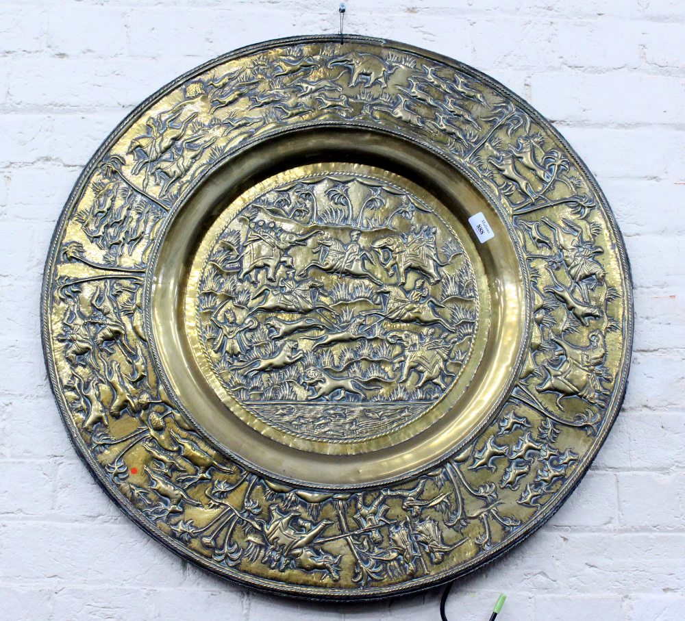 AN INDIAN CIRCULAR BRASS TRAY with hunting scenes 77cm diameter