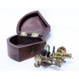 A SMALL BRASS SEXTANT 10cm high with a shaped case