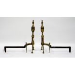 A PAIR OF ANTIQUE BRASS FIRE DOGS each 50cm in height, a 19th Century pierced brass fender 98cm wide