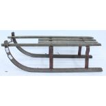 AN OLD WOOD AND IRON CHILD'S TOBOGGAN 85cm long