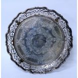 A LATE VICTORIAN PIERCED SILVER SALVER with a pie crust edge, four scrolling feet and marks for
