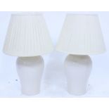 A PAIR OF CRACKLE GLAZED POTTERY TABLE LAMPS of baluster form with pleated shades 70cm high