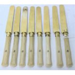 A SET OF EIGHT 19TH CENTURY IVORY HANDLED FRUIT DESSERT KNIVES with gilt metal blades, each 19.5cm