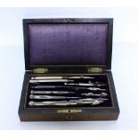 AN ANTIQUE ROSEWOOD CASED DRAWING INSTRUMENT SET with various compasses and dividers, parallel rules