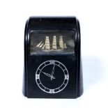 Vitascope Bakelite automation clock with chrome chapter ring on black base, with rocking ship