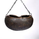 A Qajar carved large coco de mer hermit flask (kashkul) 19th/20th Century with Islamic calligraphy