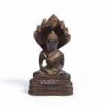 A Himalayan bronze Naga Buddha 18th Century the figure resting on a serpent base, 12cm high