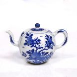 A Chinese blue and white ovoid teapot Kangxi (1662-1722) with rock work and flower panels, 16cm