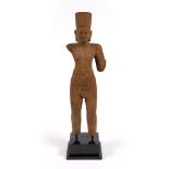 A Khmer sandstone standing torso of a deity in the 11th Century angkor style the figure wearing a