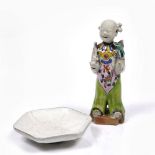 A Chinese porcelain figure of a standing youth late 18th Century holding a sho and a lotus flower,