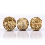 Three ivory spheres carved with squirrels, grapevines, birds and monkeys