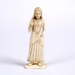 A Goanese ivory carved girl 19th Century with one hand raised, in a pleated dress with necklace,