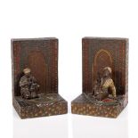 A pair of Austrian cold painted bookends 19th Century each with an Arab kneeling on a rug, 15cm