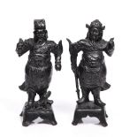 Two Chinese bronze guardians Ming period the standing figures in uniform,one holding a staff and