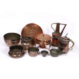 A collection of Iranian copper to include various vessels, and a pan with burner on a copper tray (