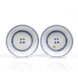 A pair of Chinese blue and white saucer dishes 18th/19th Century decorated long tailed phoenix