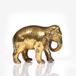 An Indian brass model elephant 19th Century the front leg stamped Patole, 17cm across, 11.75cm high