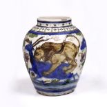 A Persian polychrome vase 19th Century depicting a lion attacking a stag, 21.5cm