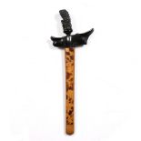 An Indonesian Kris with carved ebony handle and silver metal inlaid blade, the wood scabbard