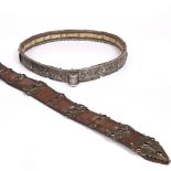 A Dagestan white metal belt made up of articulating sections laid on leather, embossed with a